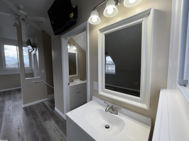 bathroom with vaulted ceiling, ceiling fan, vanity, and hardwood / wood-style floors