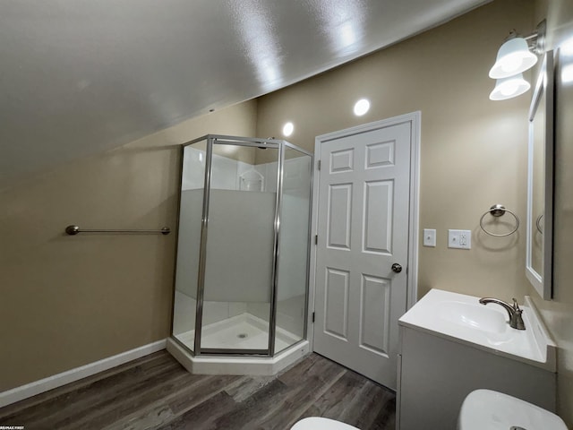 bathroom featuring hardwood / wood-style flooring, vanity, toilet, and a shower with door
