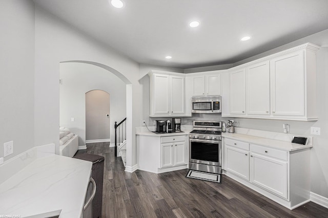 kitchen featuring white cabinetry, dark wood-type flooring, and appliances with stainless steel finishes