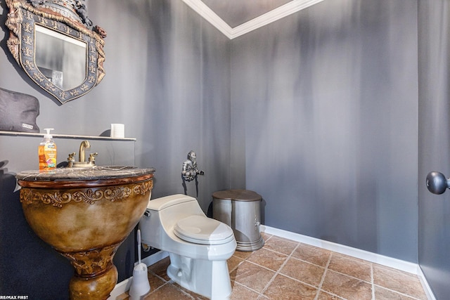 bathroom with ornamental molding and toilet