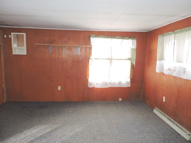 carpeted empty room with baseboard heating