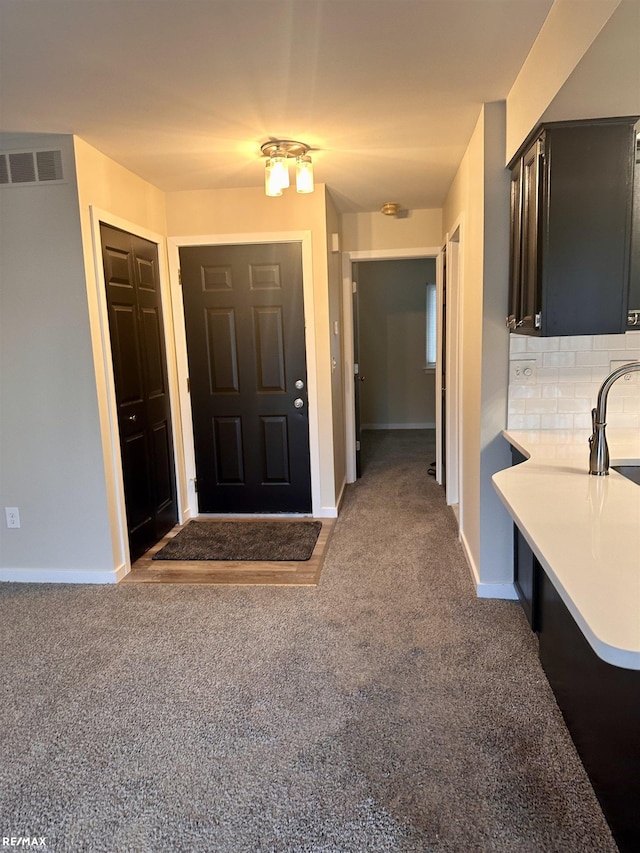 view of carpeted foyer