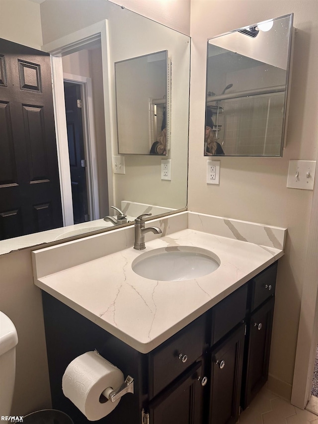 bathroom with vanity and toilet