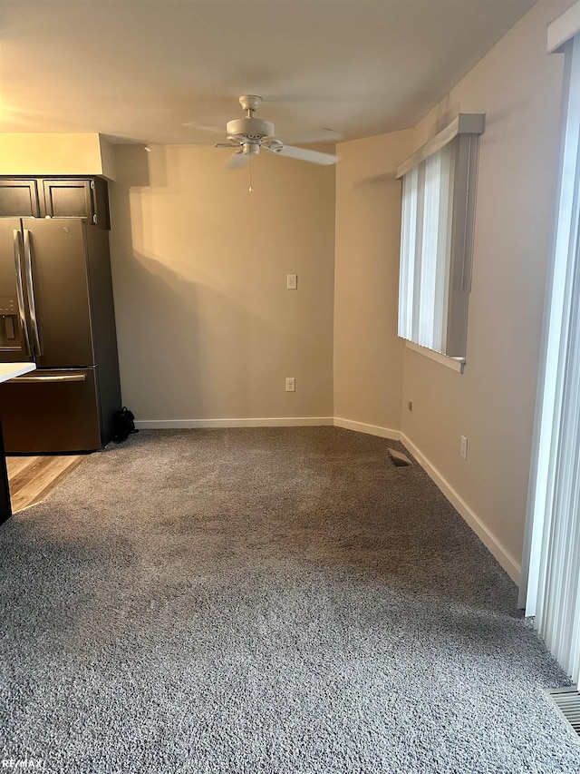 interior space featuring ceiling fan and carpet flooring