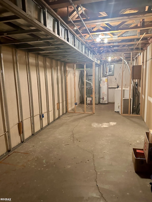 basement featuring washer / clothes dryer and water heater