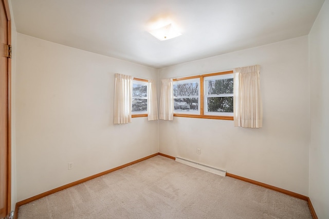 spare room with carpet and baseboard heating