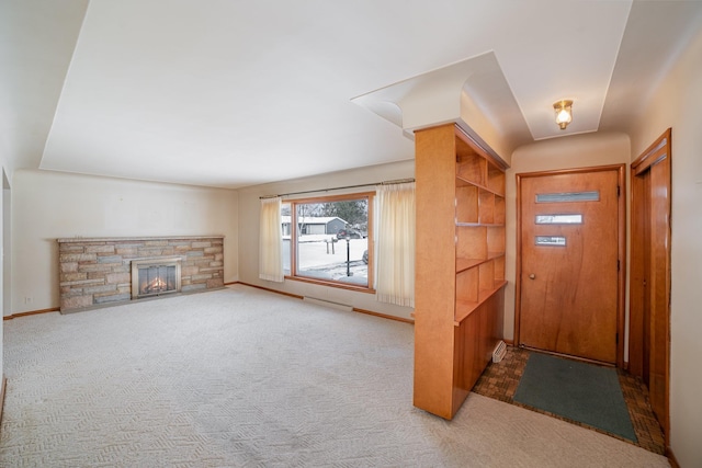 foyer with a fireplace and carpet floors