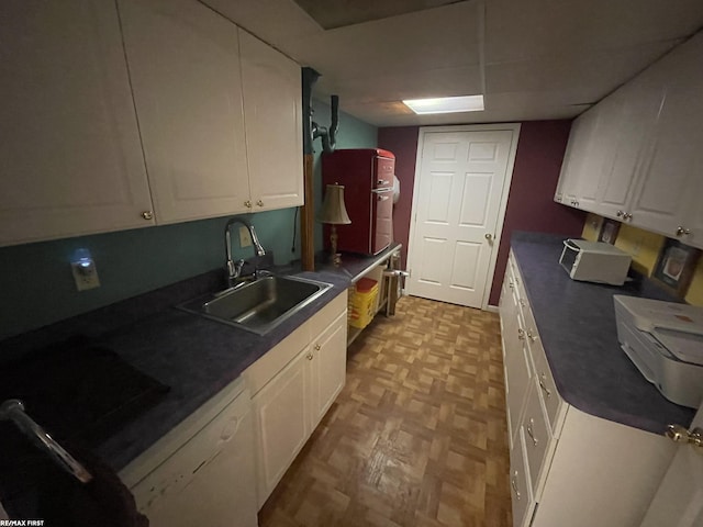 kitchen with sink, light parquet flooring, dishwasher, and white cabinets