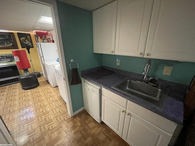 kitchen featuring white cabinetry, sink, white dishwasher, and stove