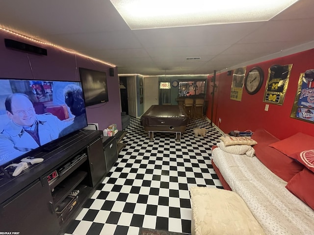 cinema room featuring a drop ceiling