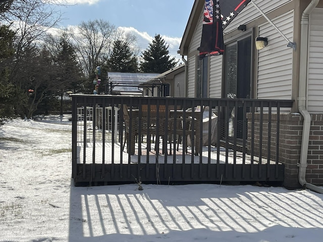 snow covered gate with a deck