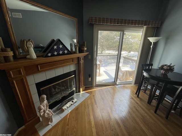 living room featuring wood-type flooring and a fireplace