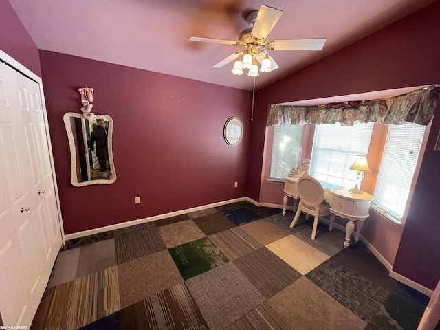 interior space with ceiling fan and vaulted ceiling