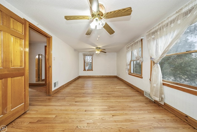 empty room featuring light hardwood / wood-style floors and a textured ceiling