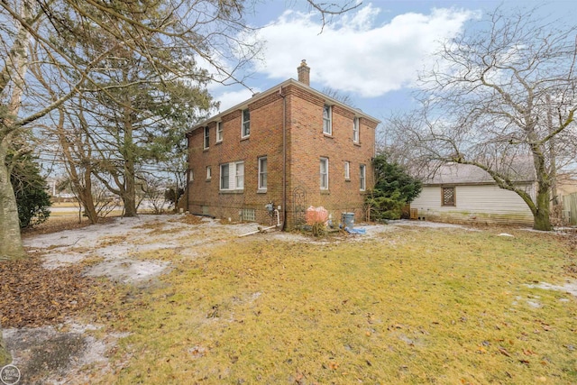 view of side of home with a yard