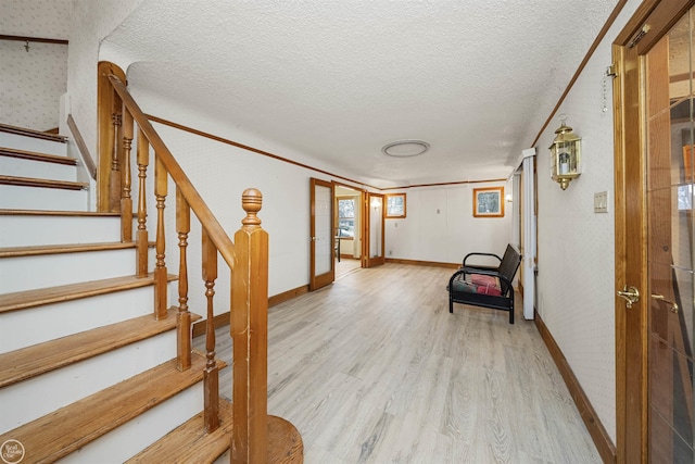 interior space with french doors, light hardwood / wood-style flooring, and a textured ceiling