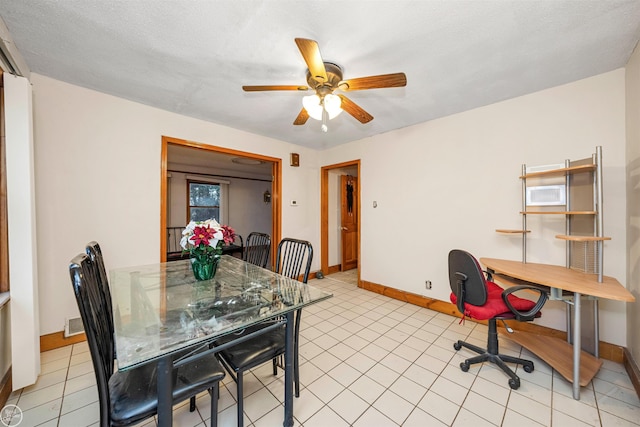 tiled dining space with ceiling fan