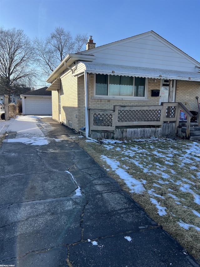 view of front of house featuring a garage and an outdoor structure