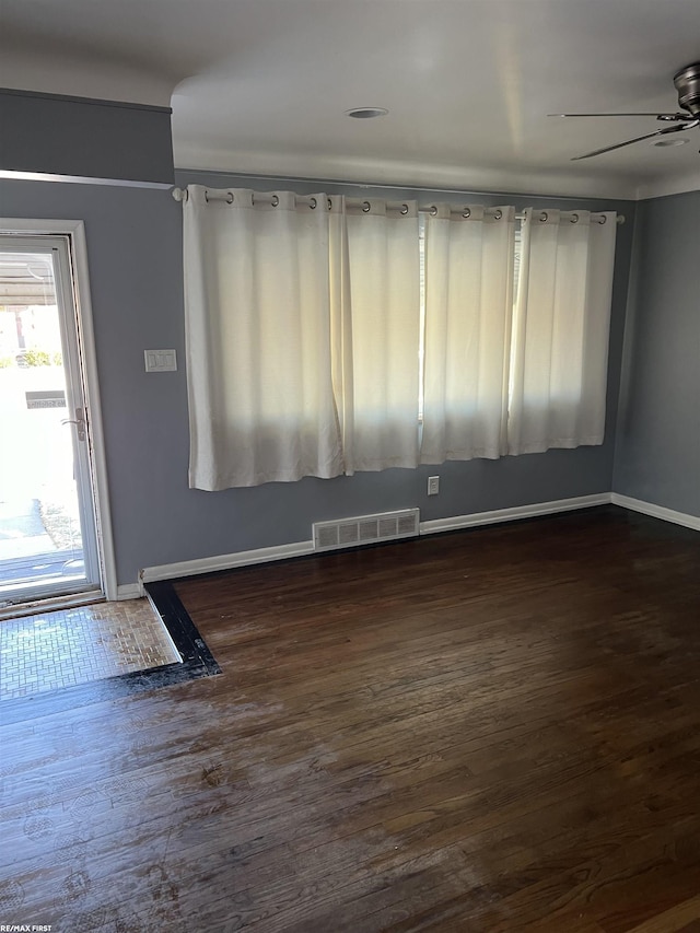 unfurnished room featuring dark hardwood / wood-style floors and ceiling fan