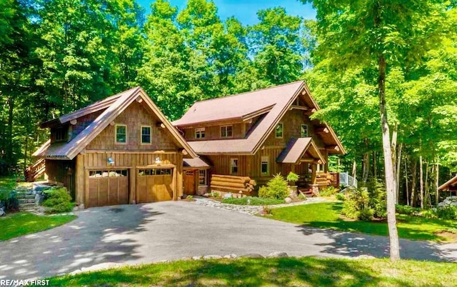 log home with a garage and a front yard