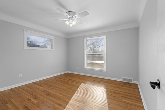 unfurnished room with ceiling fan, a healthy amount of sunlight, and light hardwood / wood-style flooring