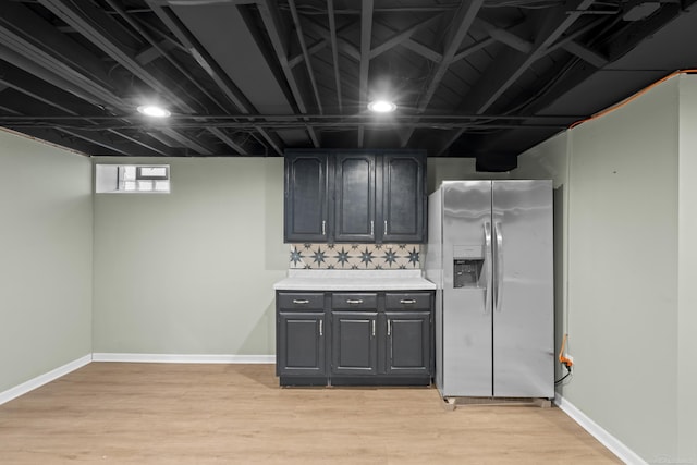 kitchen featuring decorative backsplash, stainless steel fridge, and light hardwood / wood-style floors