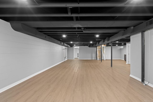 basement featuring hardwood / wood-style floors