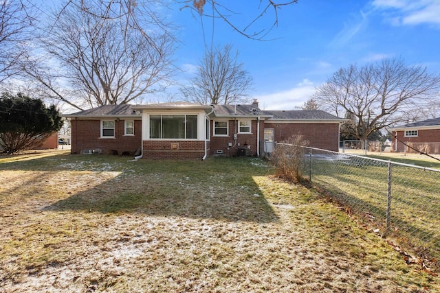 ranch-style home featuring cooling unit and a front lawn