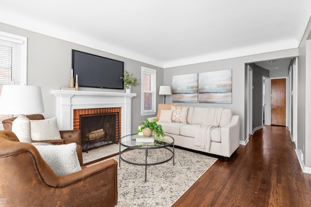 living room featuring a fireplace and dark hardwood / wood-style floors