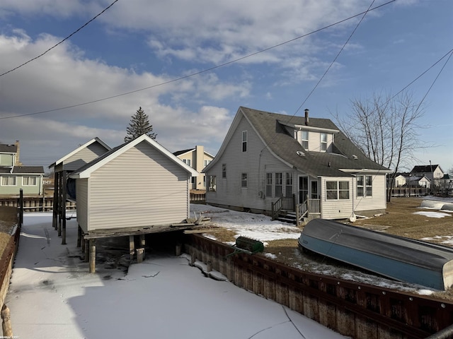 view of snow covered back of property