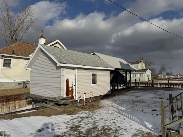 view of snow covered back of property