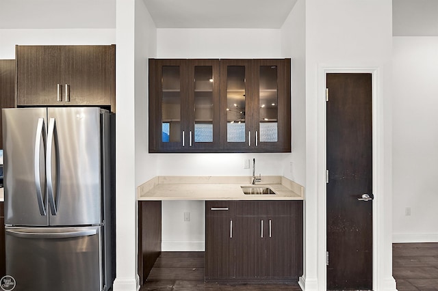 kitchen with sink, dark wood-type flooring, and stainless steel refrigerator