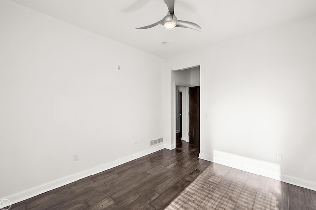 empty room with ceiling fan and dark hardwood / wood-style floors