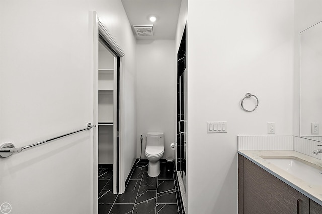 bathroom with vanity, an enclosed shower, and toilet