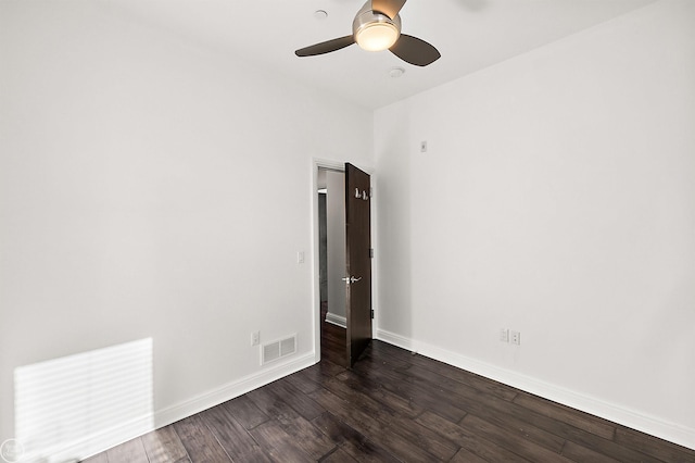 unfurnished room featuring dark wood-type flooring and ceiling fan