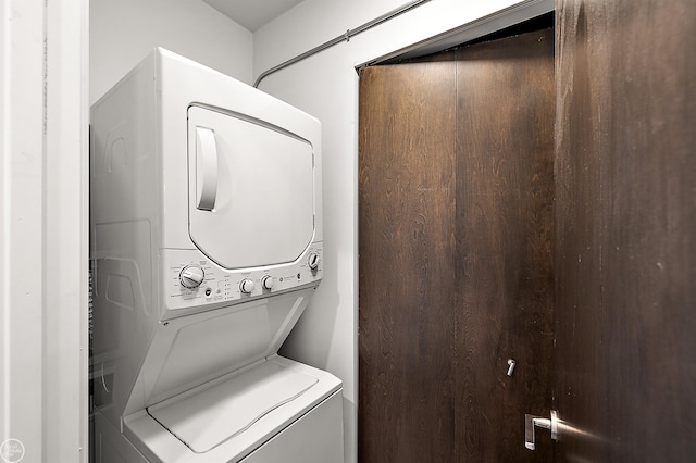 laundry room with stacked washer / dryer