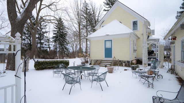 view of snow covered back of property