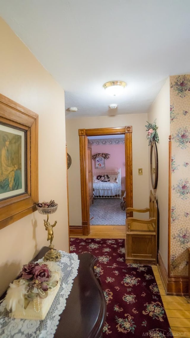 corridor with light hardwood / wood-style floors