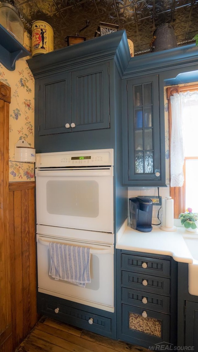 kitchen featuring white double oven and blue cabinets