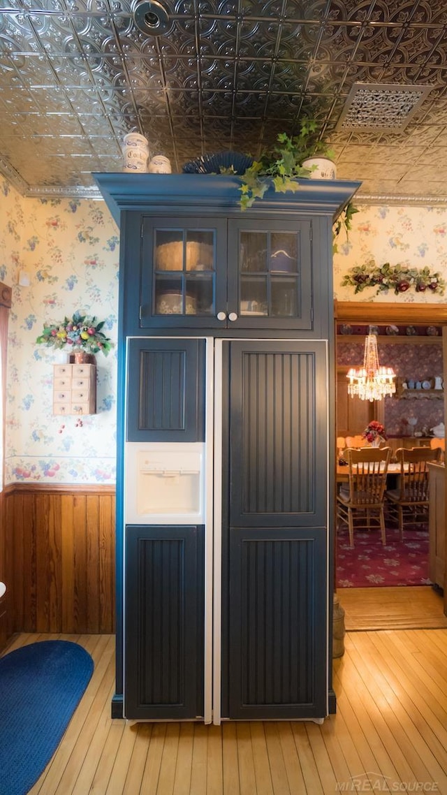 interior space featuring blue cabinets and hardwood / wood-style floors