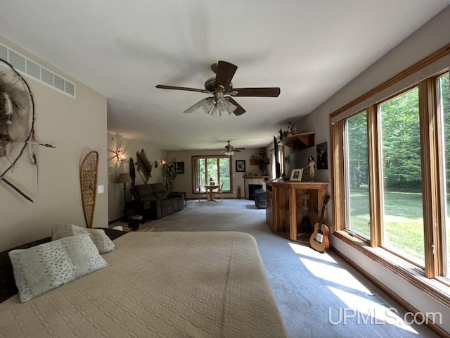 bedroom with ceiling fan and light carpet