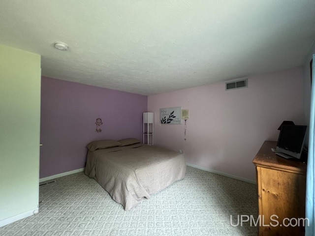 bedroom with light colored carpet