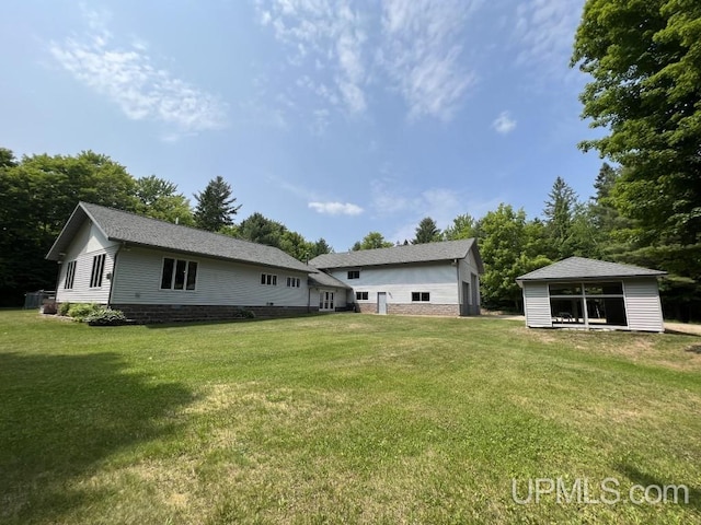 rear view of property featuring a yard