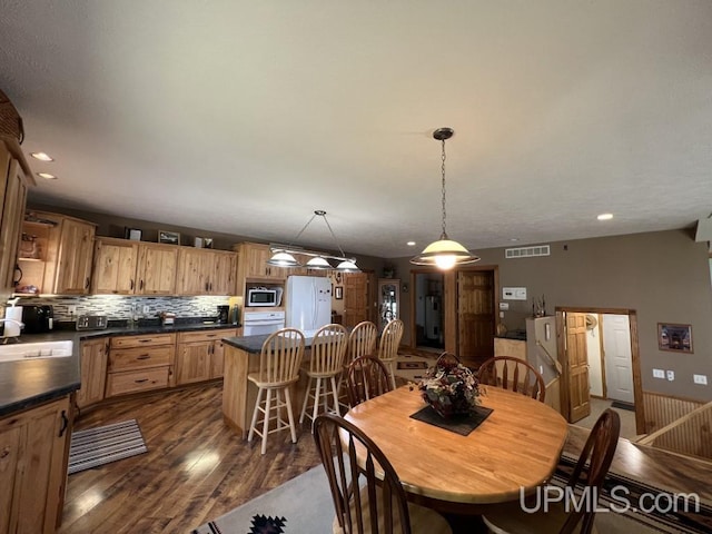 dining space with sink and dark hardwood / wood-style floors