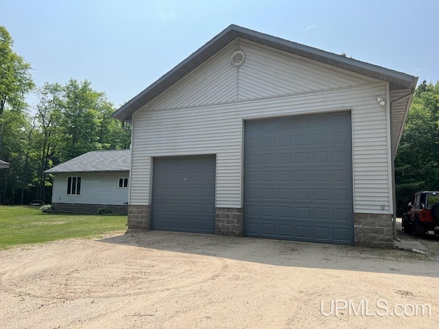 garage featuring a lawn