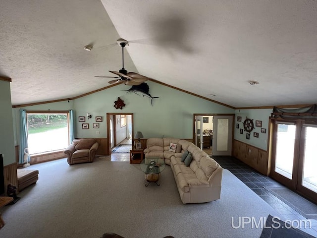 unfurnished living room with crown molding, vaulted ceiling, a textured ceiling, and wood walls