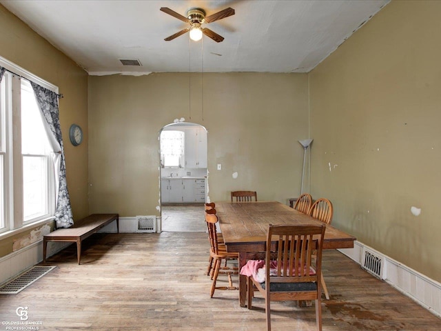 dining space with ceiling fan, a healthy amount of sunlight, and hardwood / wood-style floors