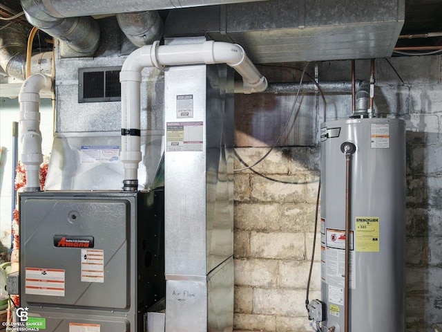 utility room featuring heating unit and water heater