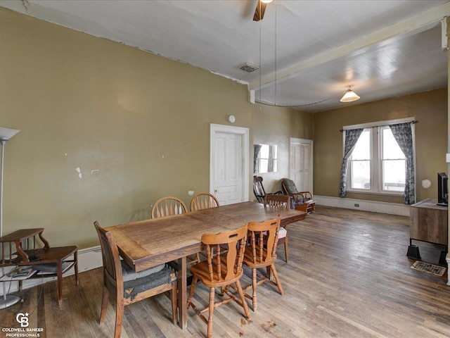 dining area featuring hardwood / wood-style floors, ceiling fan, and a baseboard heating unit