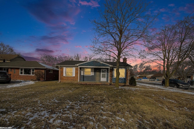 ranch-style home with a lawn